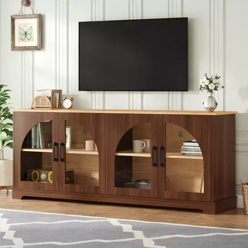 Farmhouse-style TV console with semi-arched glass doors, accommodates TVs up to 70 inches. Wood-grain sideboard with adjustable shelves, Walnut